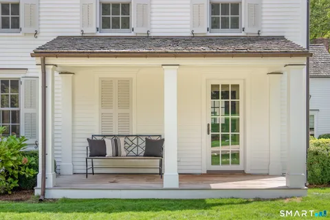 a view of a house with a backyard and sitting area