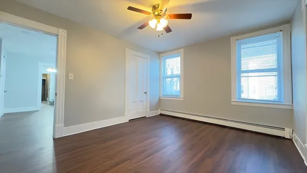 wooden floor in an empty room with a window