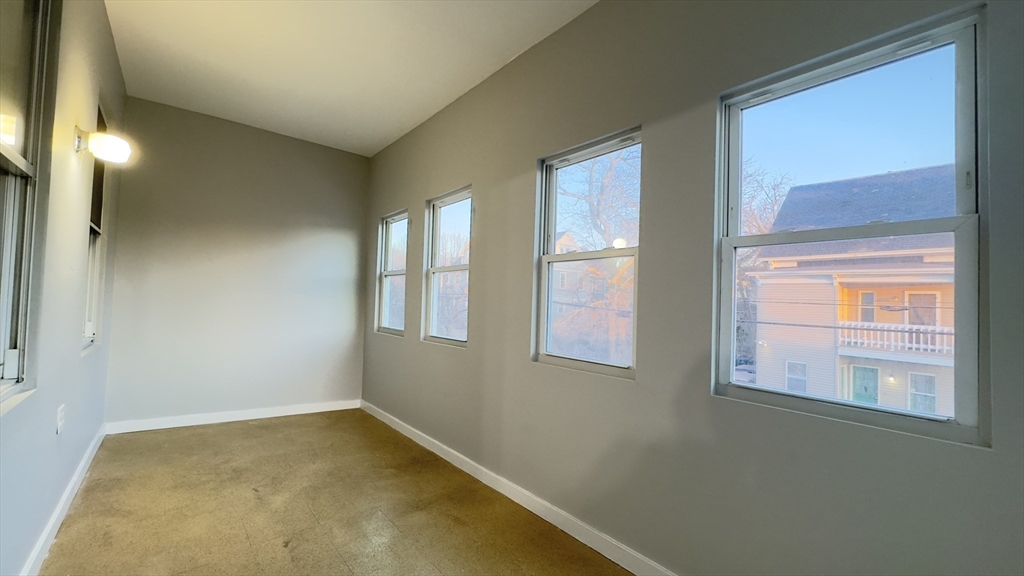 150 Pleasant Street, Unit 1 Lowell, MA 01852 - Photo 7 of 19 a view of room and window