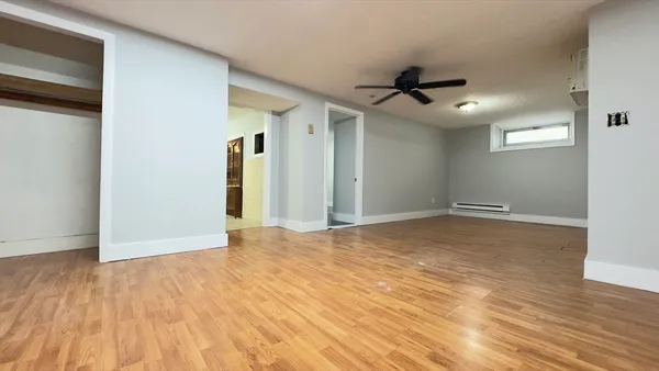 a view of an empty room and wooden floor
