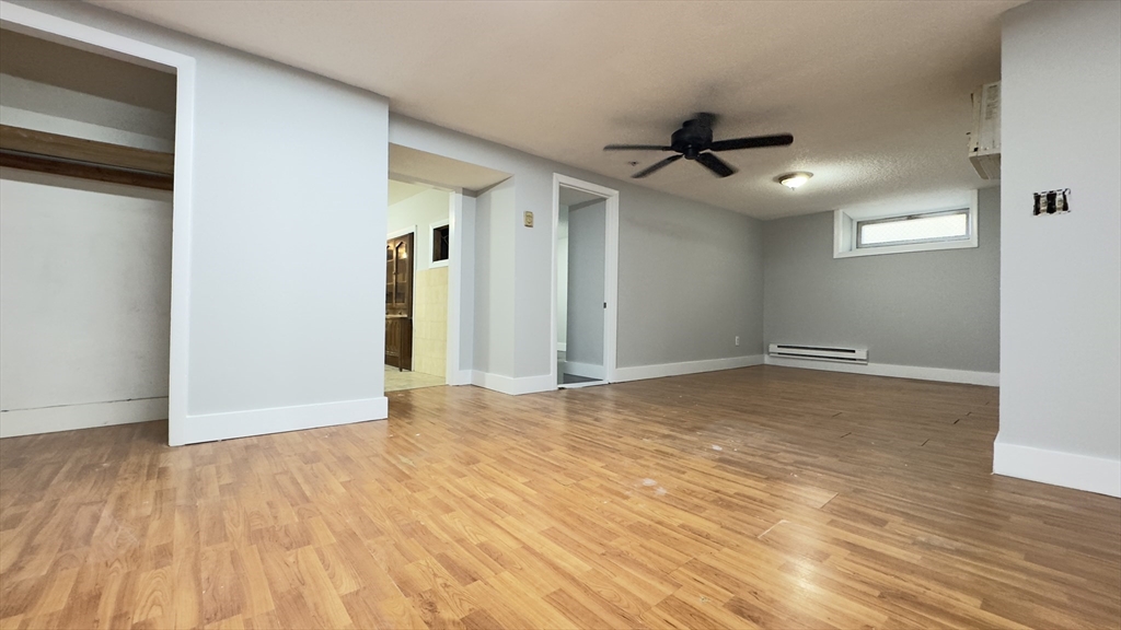 150 Pleasant Street, Unit 1 Lowell, MA 01852 - Photo 10 of 19 a view of an empty room and wooden floor