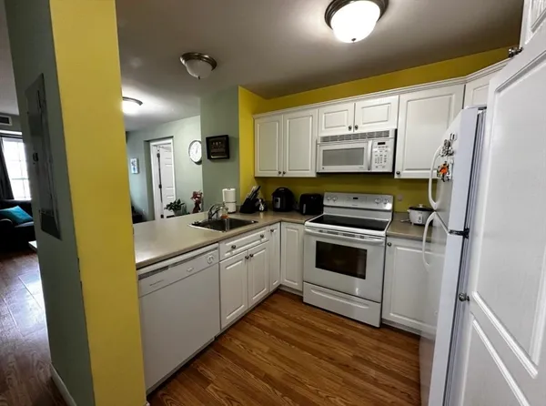 a kitchen with a refrigerator cabinets and a sink