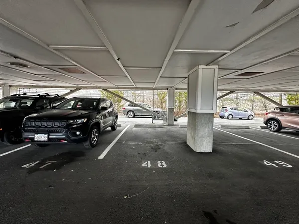 a view of parking garage with cars