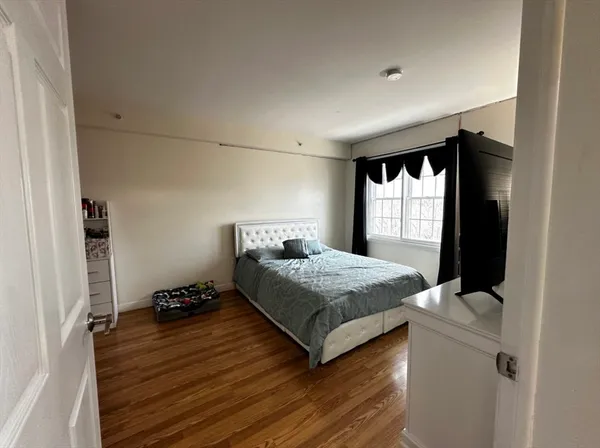 a bedroom with a bed and window