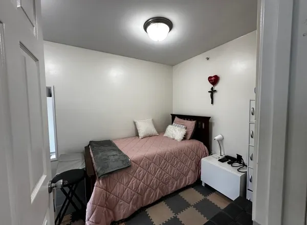 a bedroom with a bed and a couch