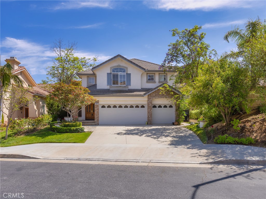 20316 Wynfreed Lane Porter Ranch, CA 91326 - Photo 2 of 51 a front view of a house with a yard and garage