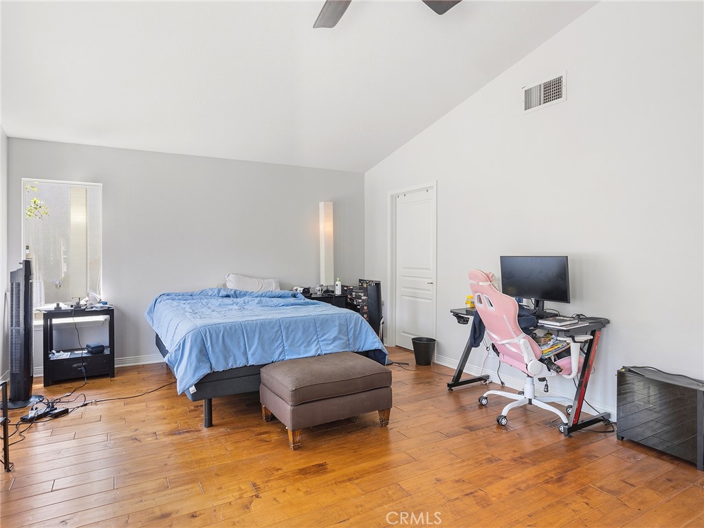 20316 Wynfreed Lane Porter Ranch, CA 91326 - Photo 21 of 51 a bedroom with a bed a chair and a dresser next to a window