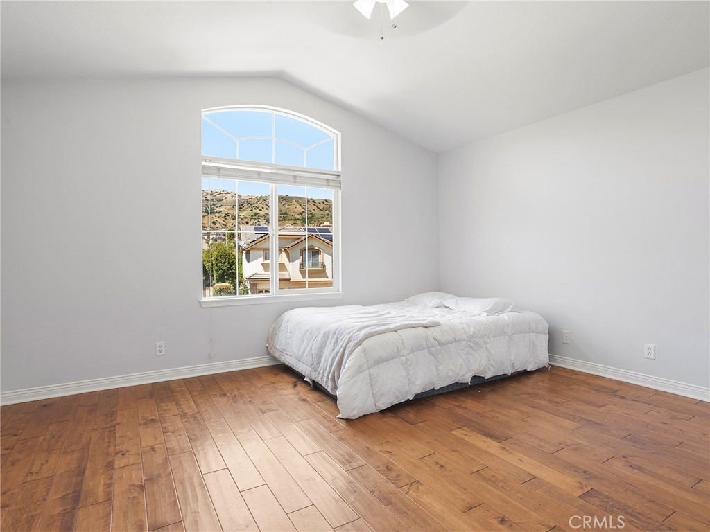 20316 Wynfreed Lane Porter Ranch, CA 91326 - Photo 24 of 51 a bedroom with a bed and a window