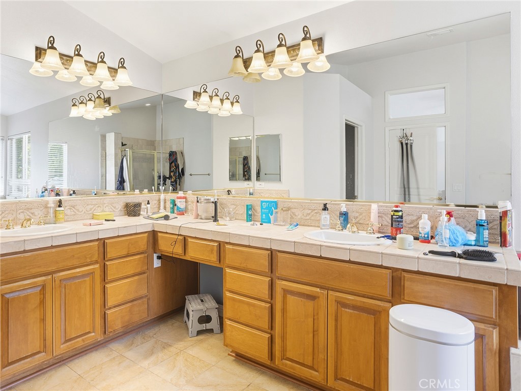 20316 Wynfreed Lane Porter Ranch, CA 91326 - Photo 27 of 51 a spacious bathroom with a sink double vanity and a mirror