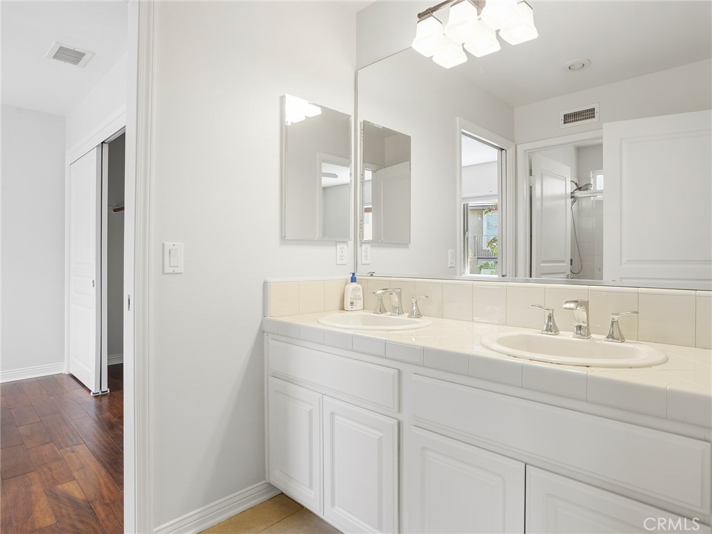 20316 Wynfreed Lane Porter Ranch, CA 91326 - Photo 30 of 51 a bathroom with a double vanity sink and a mirror