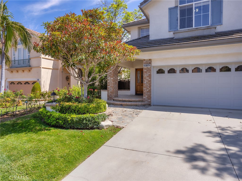 20316 Wynfreed Lane Porter Ranch, CA 91326 - Photo 4 of 51 a front view of a house with a yard