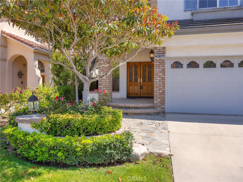 20316 Wynfreed Lane Porter Ranch, CA 91326 - Photo 5 of 51 a front view of a house with garden