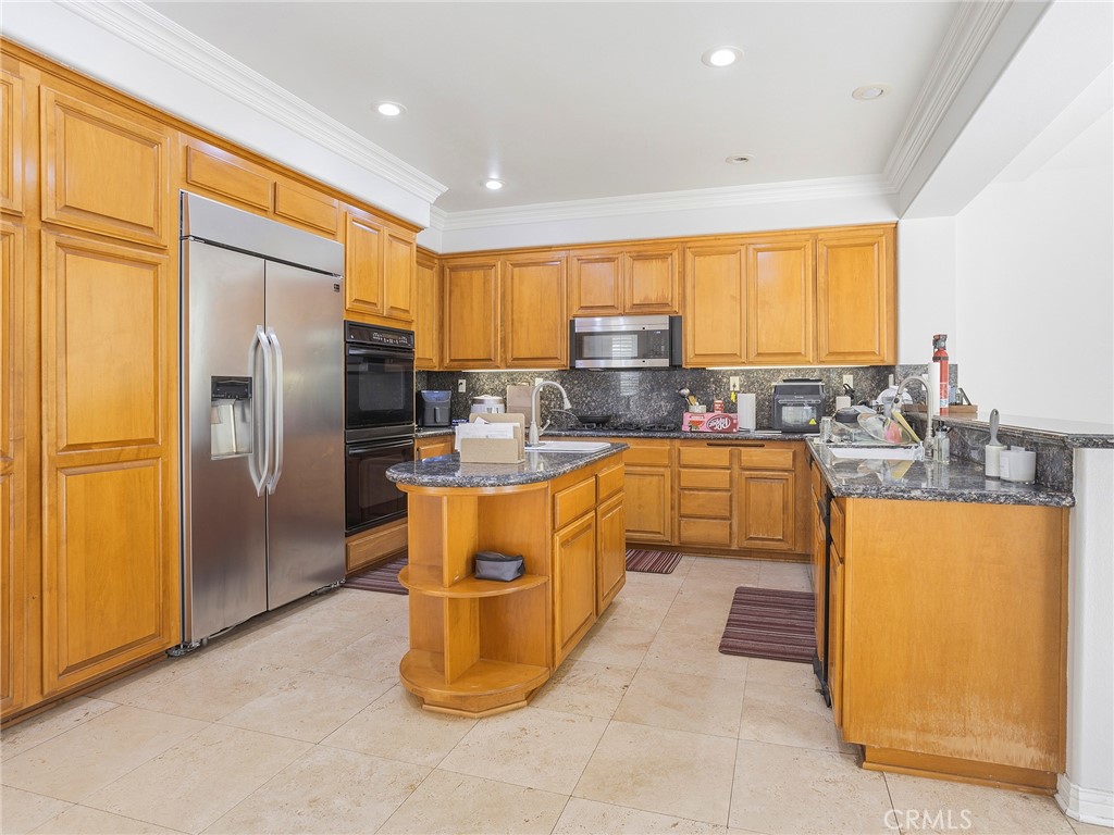 20316 Wynfreed Lane Porter Ranch, CA 91326 - Photo 7 of 51 a large kitchen with stainless steel appliances granite countertop a stove a sink dishwasher and a refrigerator