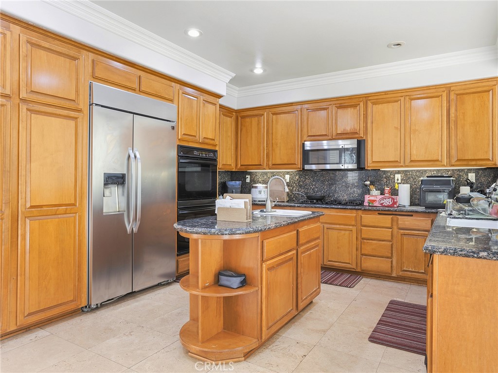20316 Wynfreed Lane Porter Ranch, CA 91326 - Photo 10 of 51 a kitchen with stainless steel appliances granite countertop a refrigerator a stove a sink and dishwasher