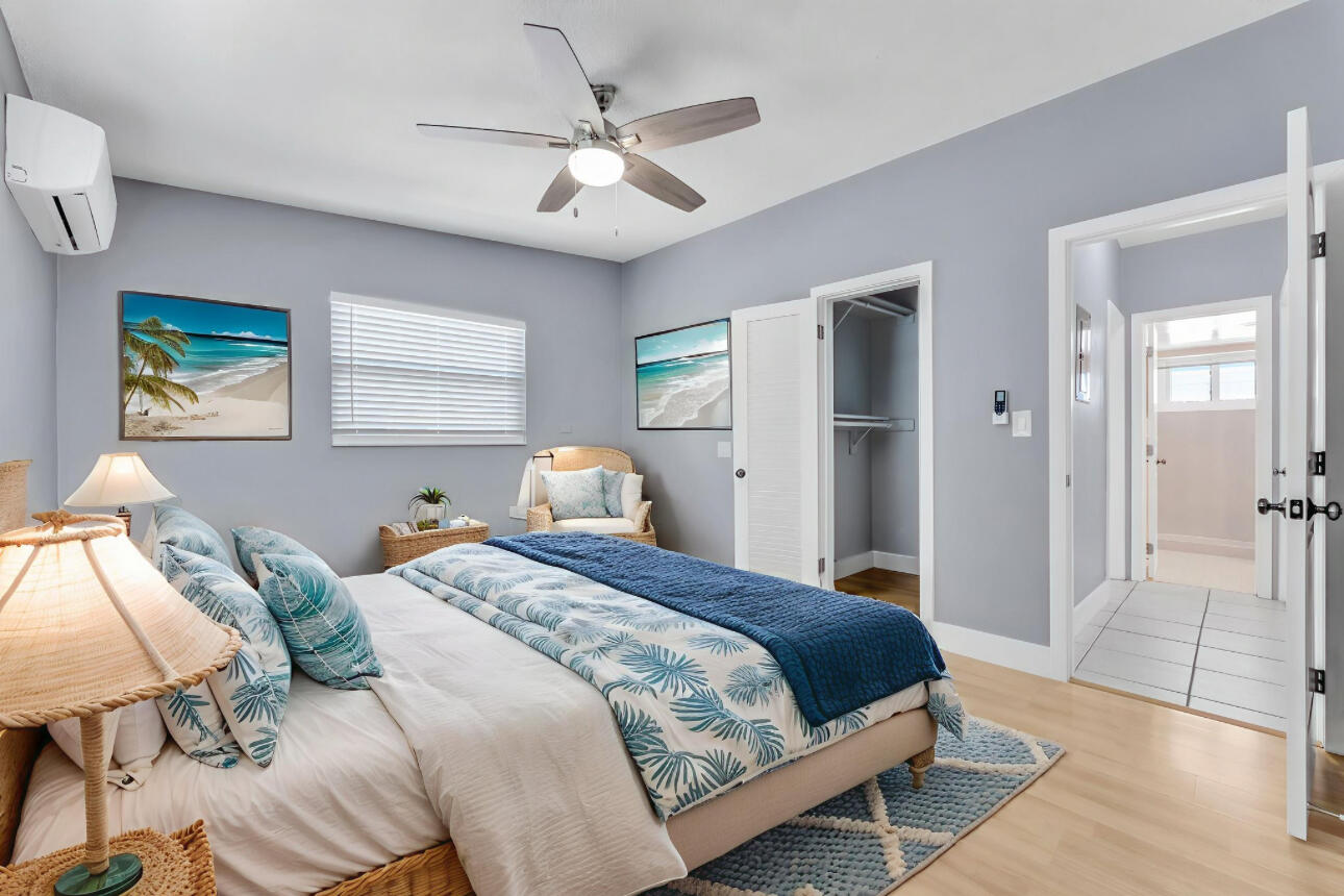 67 Coral Drive, Unit 1 Key Largo, FL 33037 - Photo 21 of 23 a bedroom with a bed and a chandelier