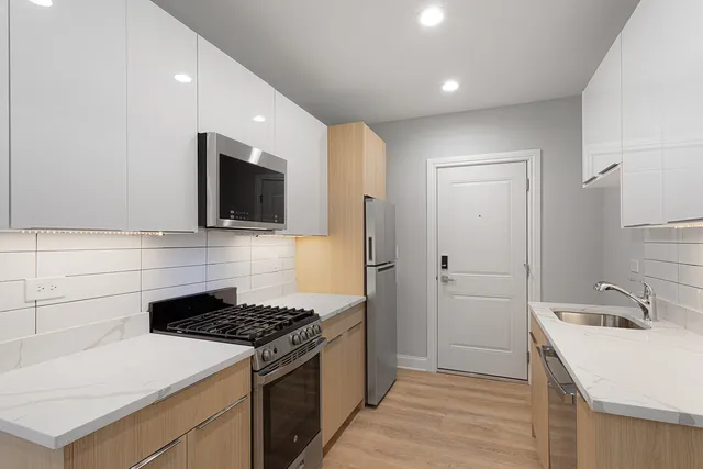 a kitchen that has a sink and a stove