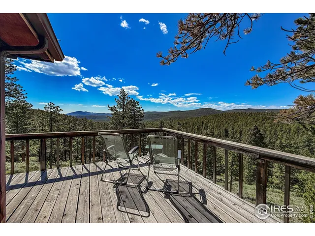 a view of a balcony with wooden floor and city view