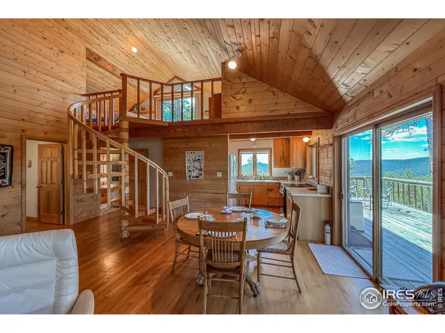 a dining room with furniture and wooden floor