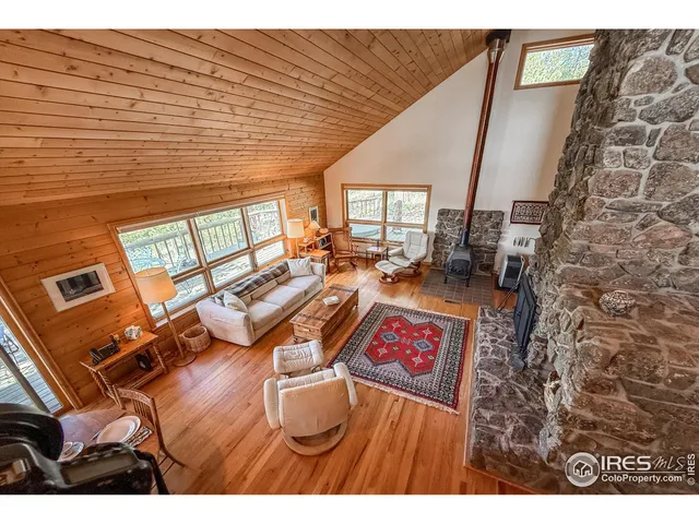 a view of a patio with chairs and floor to ceiling window