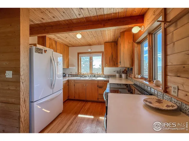 a kitchen with stainless steel appliances kitchen island granite countertop a refrigerator and a sink