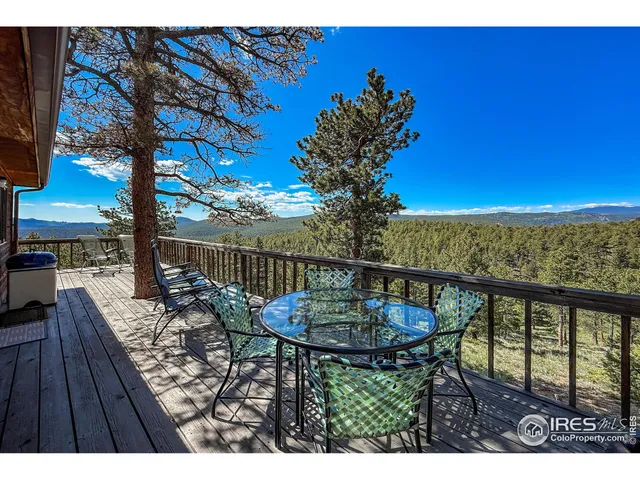 a balcony with table and chairs