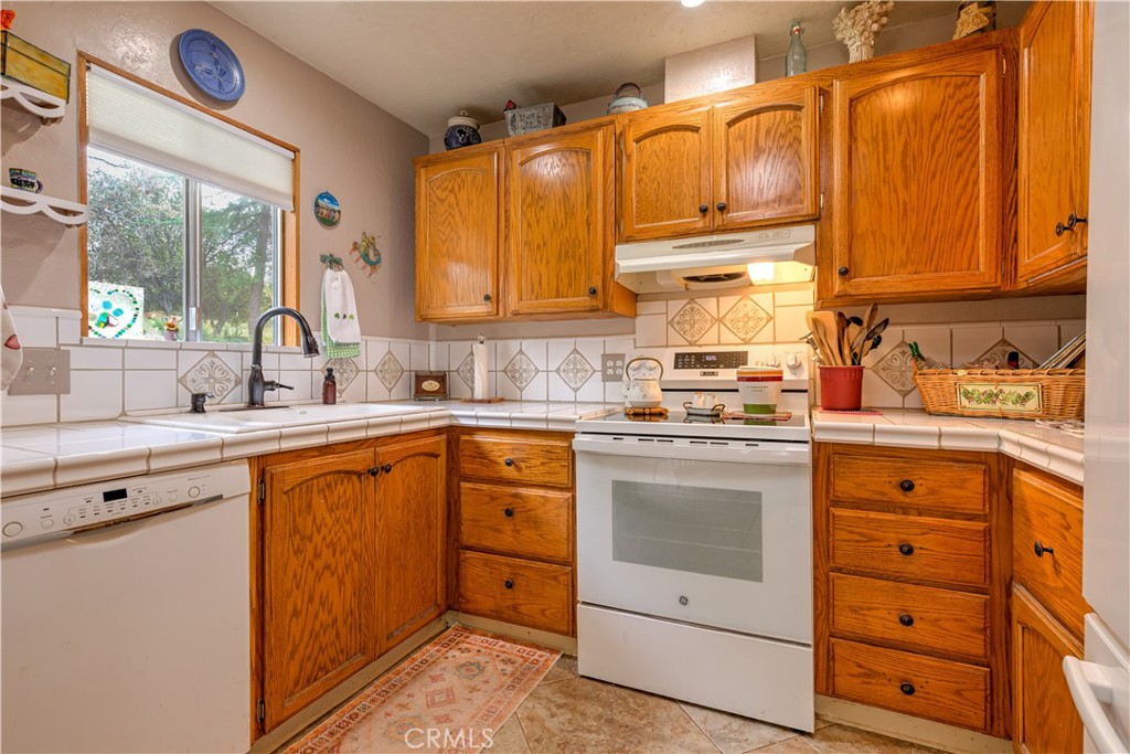 1044 Mt Ida Road Oroville, CA 95966 - Photo 21 of 44 a kitchen with cabinets appliances a sink and a window