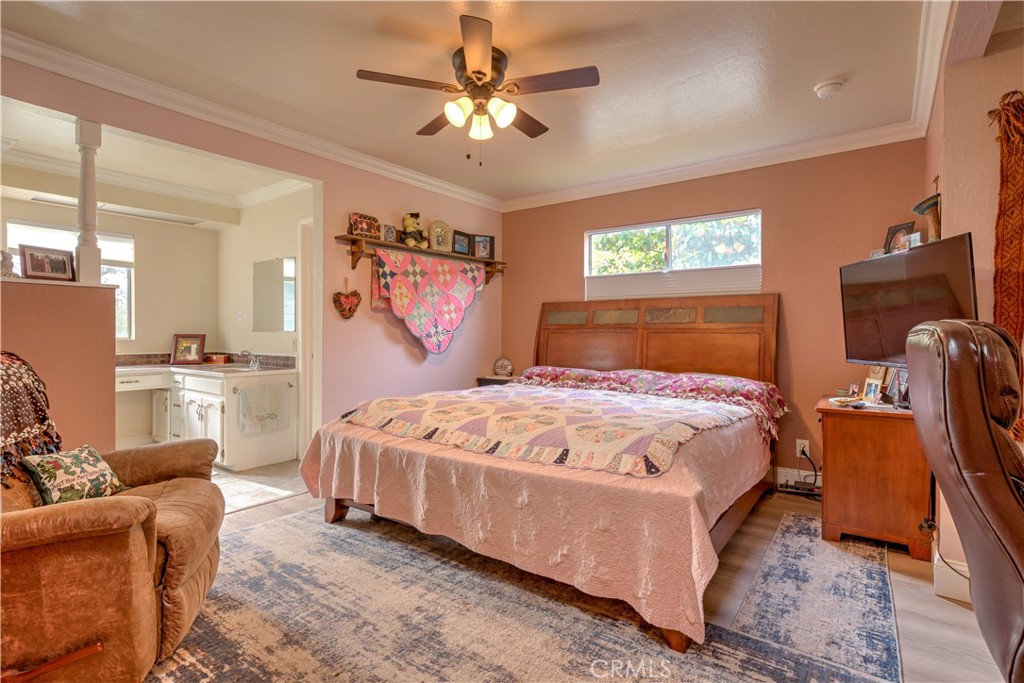 1044 Mt Ida Road Oroville, CA 95966 - Photo 25 of 44 a bedroom with a bed gym equipment and a chandelier