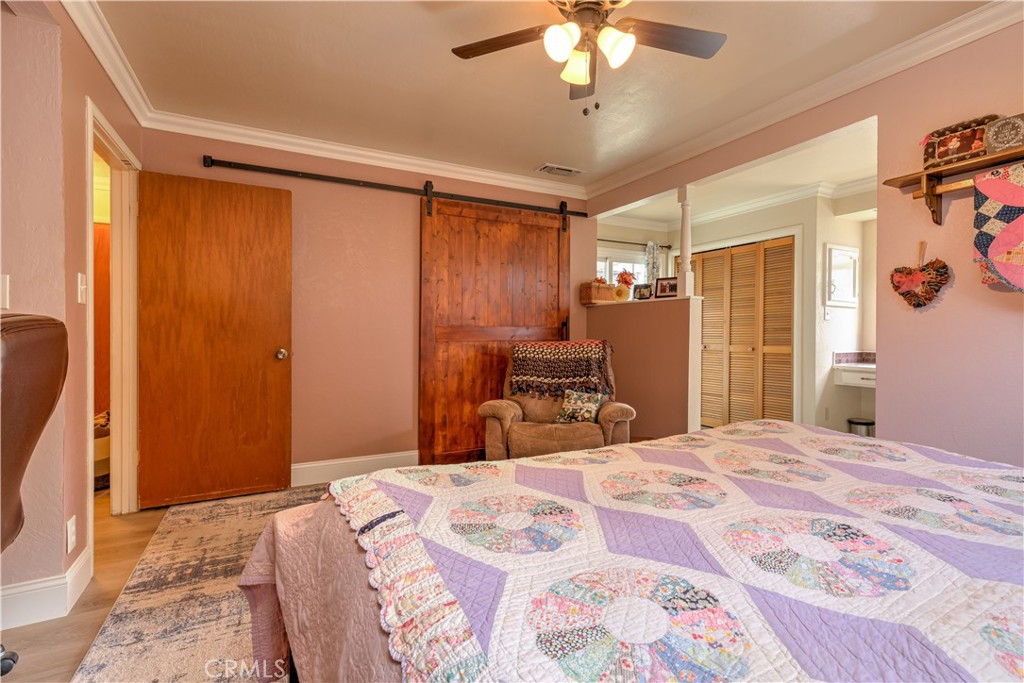 1044 Mt Ida Road Oroville, CA 95966 - Photo 26 of 44 a bedroom with a bed and a chandelier