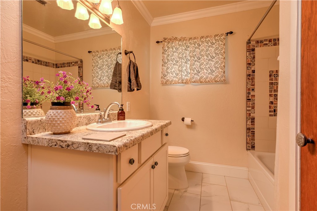 1044 Mt Ida Road Oroville, CA 95966 - Photo 33 of 44 a bathroom with a granite countertop sink a mirror and shower