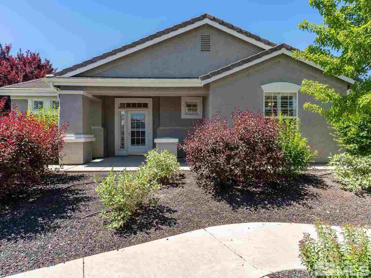 10402 Gold Trail Drive Reno, NV 89521 - Photo 1 of 16 a front view of a house with garden