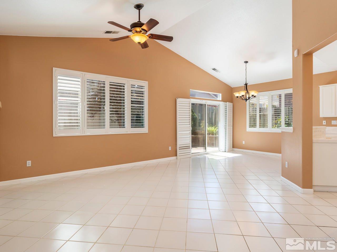10402 Gold Trail Drive Reno, NV 89521 - Photo 3 of 16 a view of an empty room with a window and a ceiling fan