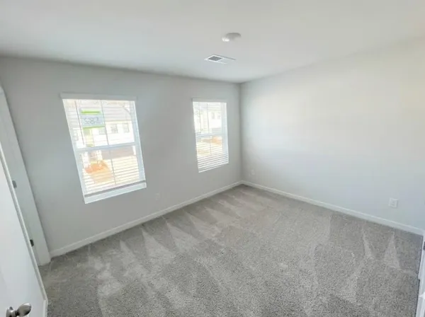 a view of backyard of house and garage