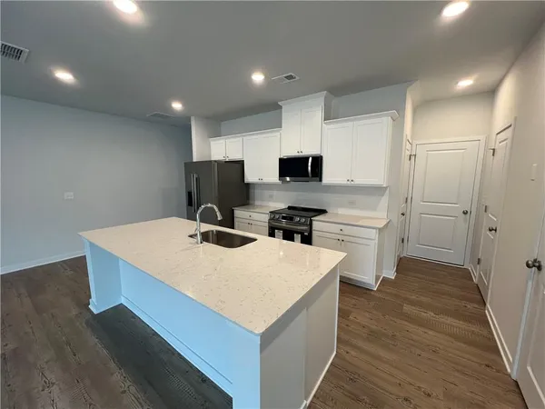 an empty room with windows and fireplace