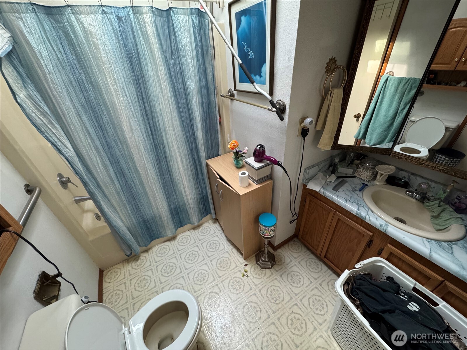 30 Restful Road Grapeview, WA 98546 - Photo 15 of 18 a bathroom with a sink a mirror and shower