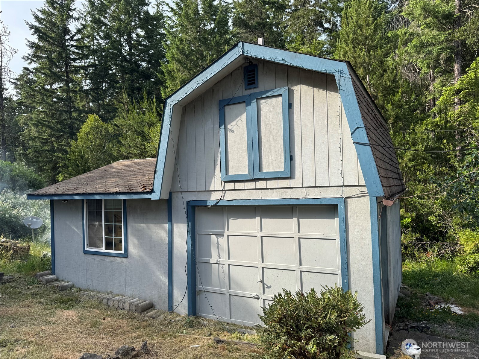 30 Restful Road Grapeview, WA 98546 - Photo 4 of 18 a front view of a house with garden