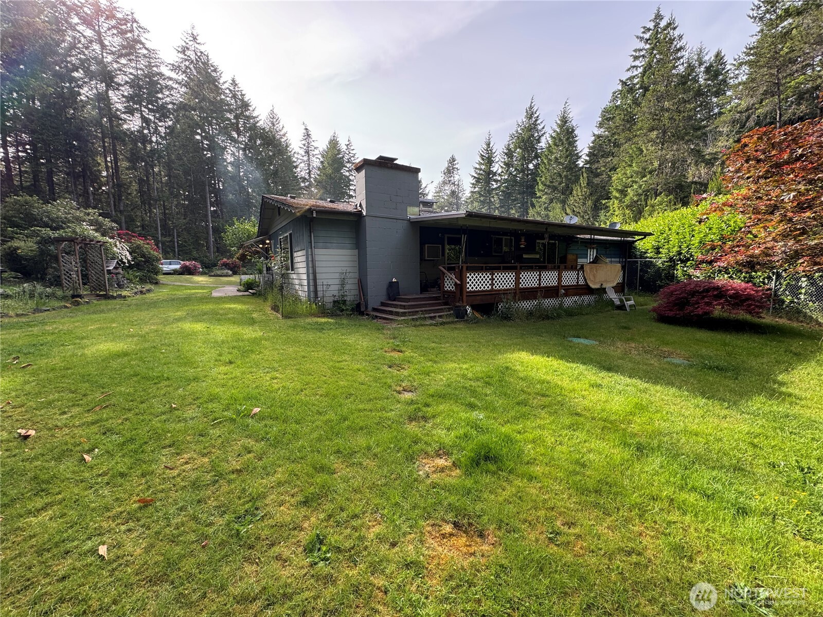 30 Restful Road Grapeview, WA 98546 - Photo 10 of 18 a view of a house with a yard and sitting area