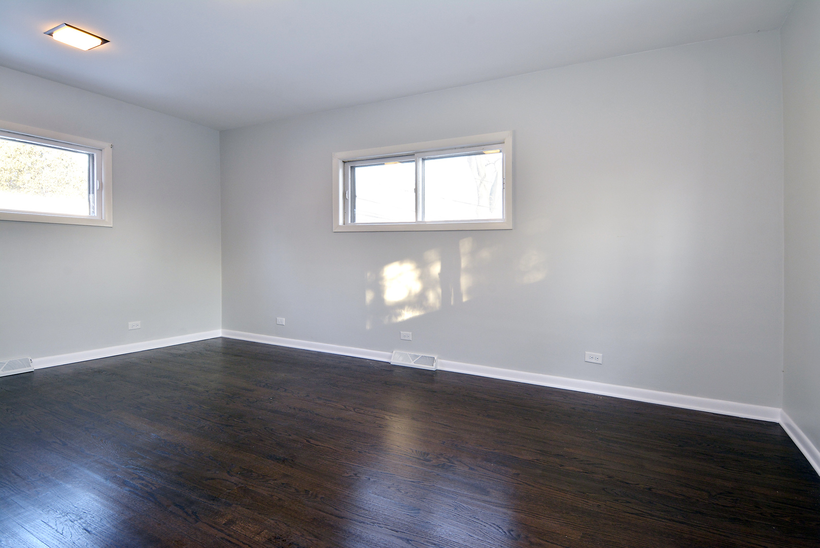 1322 West Central Road Mount Prospect, IL 60056 - Photo 13 of 28 a view of an empty room with wooden floor and a window