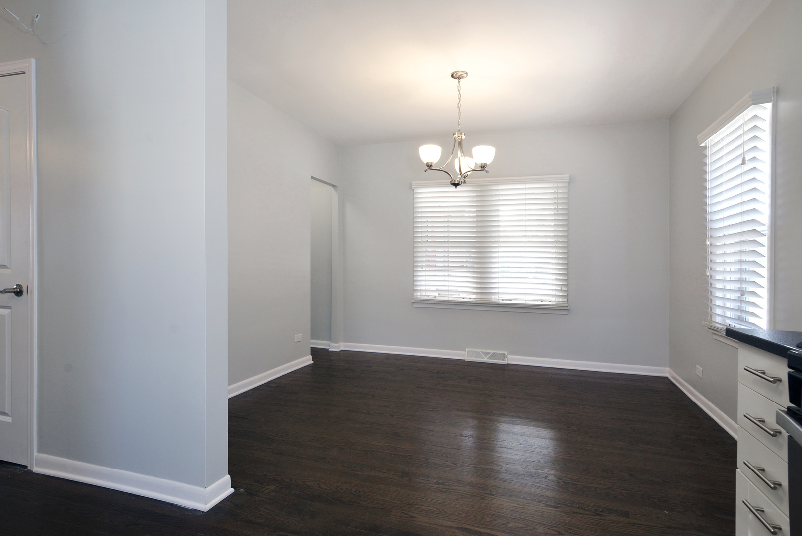 1322 West Central Road Mount Prospect, IL 60056 - Photo 5 of 28 an empty room with wooden floor chandelier and window