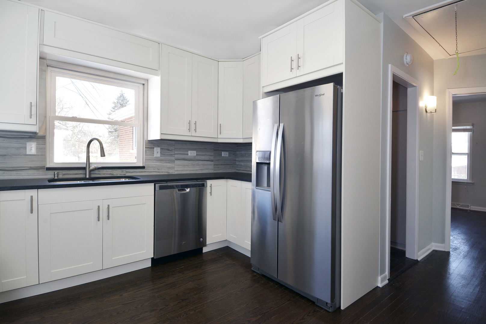 1322 West Central Road Mount Prospect, IL 60056 - Photo 7 of 28 a kitchen with stainless steel appliances granite countertop a refrigerator sink and white cabinets