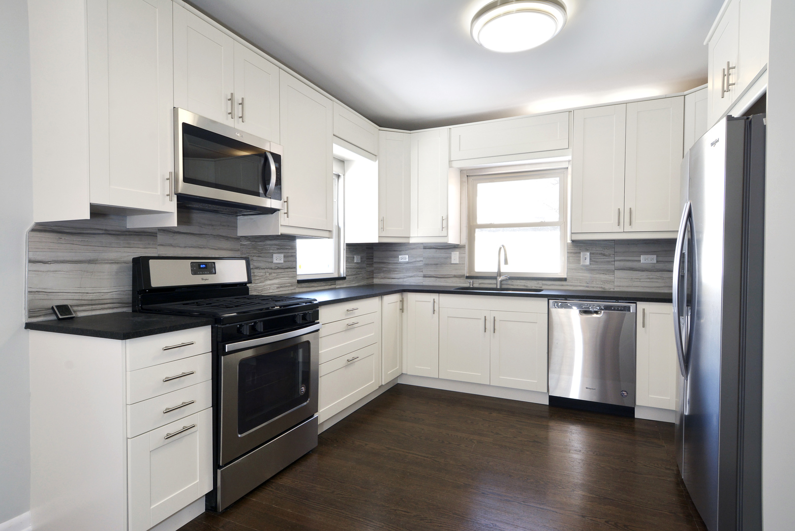 1322 West Central Road Mount Prospect, IL 60056 - Photo 8 of 28 a kitchen with granite countertop a sink and steel appliances