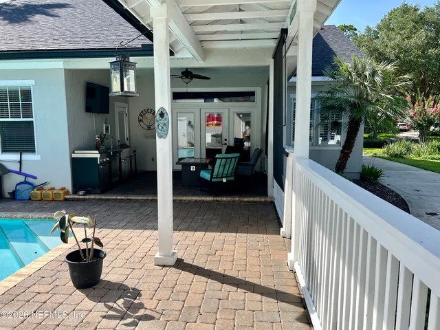 a view of a porch with dining table and chairs