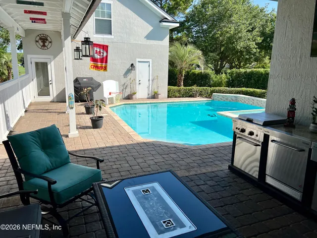 swimming pool view with a seating space