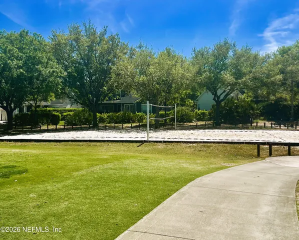 a view of a swimming pool with a lawn chairs under an umbrella