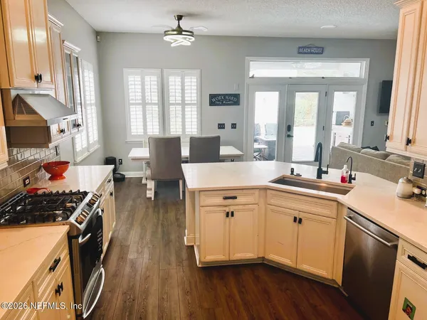 a kitchen with a sink stove and cabinets
