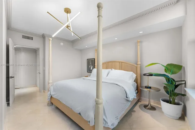 a view of a hallway with a dining table and chandelier