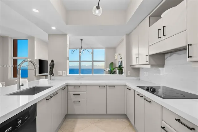 a kitchen with stainless steel appliances kitchen island granite countertop a sink and cabinets