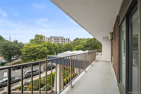a view of a balcony with wooden floor and fence