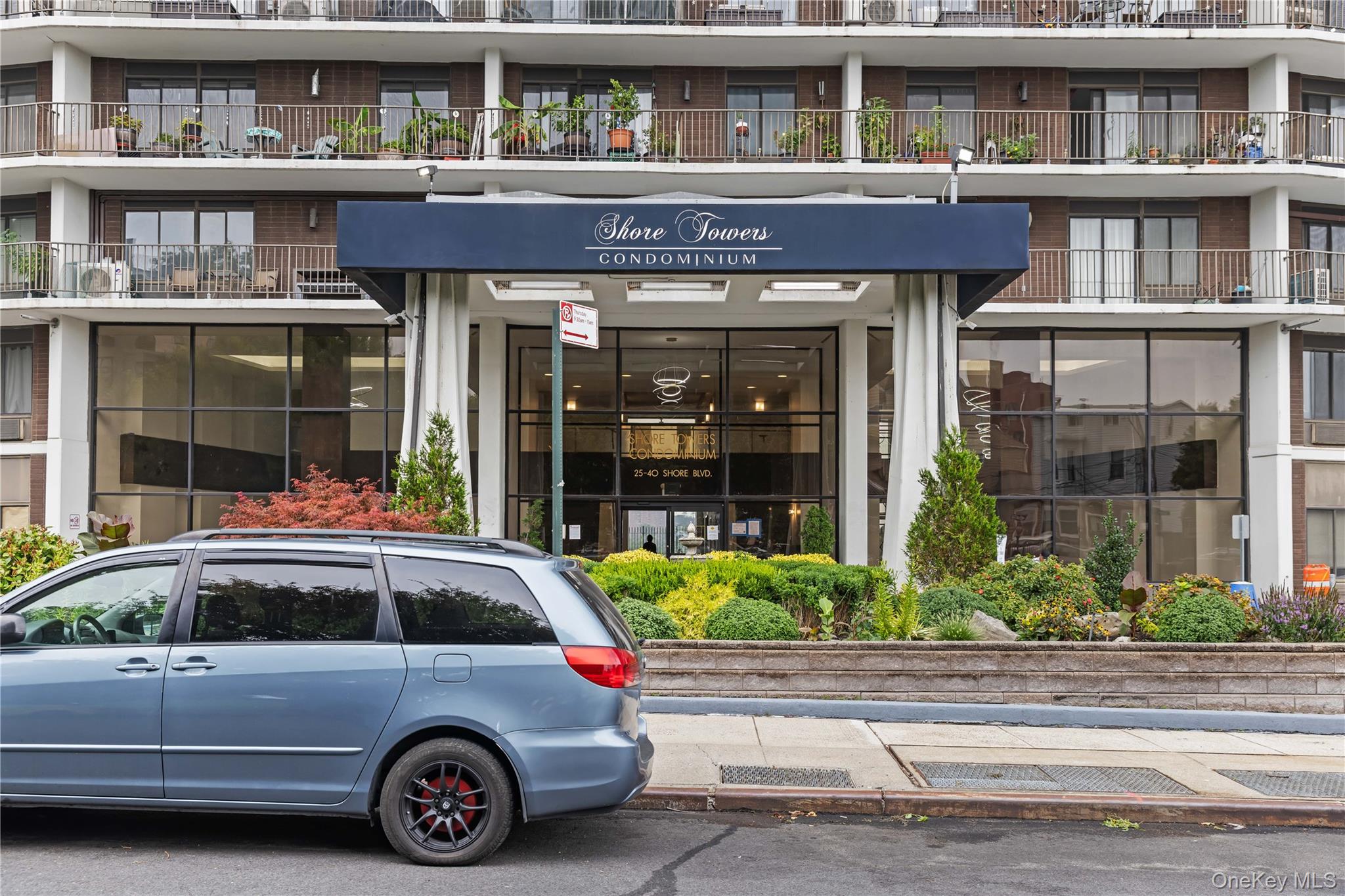 25-40 Shore Boulevard, Unit 2E Queens, NY 11102 - Photo 20 of 21 a car parked in front of a houses