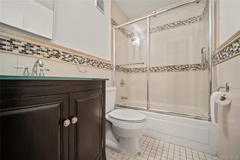 a bathroom with a shower a toilet and sink