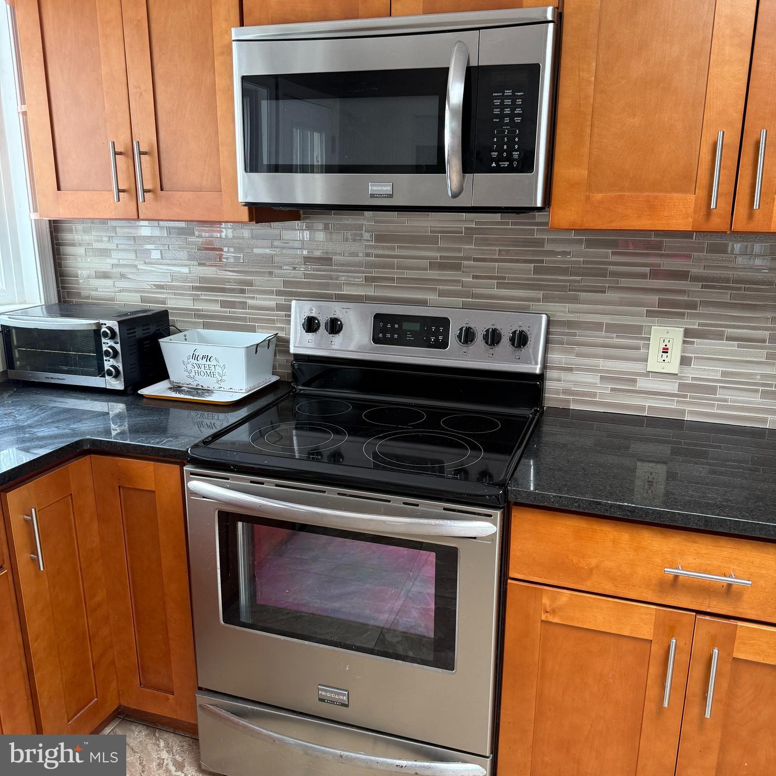 2621 Old Welsh Road Willow Grove, PA 19090 - Photo 5 of 10 a kitchen with stainless steel appliances granite countertop wooden cabinets and a stove top oven